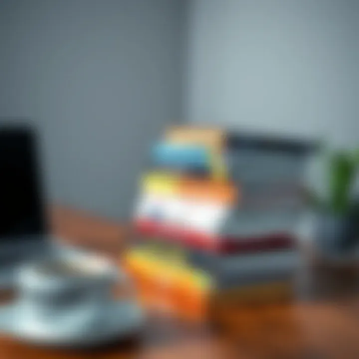 Collection of forex trading books stacked on a wooden table with a laptop and a cup of coffee nearby